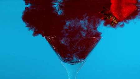 We blow up green and red smoke bombs in an aquarium with waterの写真素材