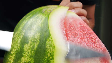 Watermelon slices, a cut piece of watermelon placed in a transparent glass bowlの写真素材