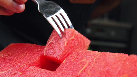 Watermelon slices, a cut piece of watermelon placed in a transparent glass bowl