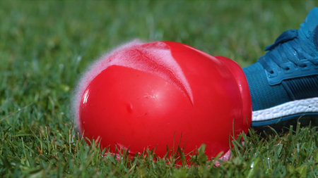 A yellow inflated balloon with multicolored balls on a blue background. Modern fashion design