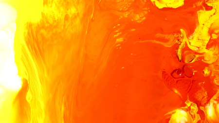 Blue orange yellow abstract background. Tinted background with copy space for design. The colors were immersed in liquid and photographed in motion. abstract compositionの写真素材