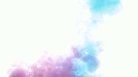 An explosion of colored paints in water on a white backgroundの写真素材