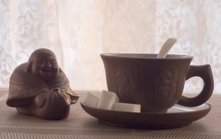 coffee Cup with gift figurine on the tableの写真素材