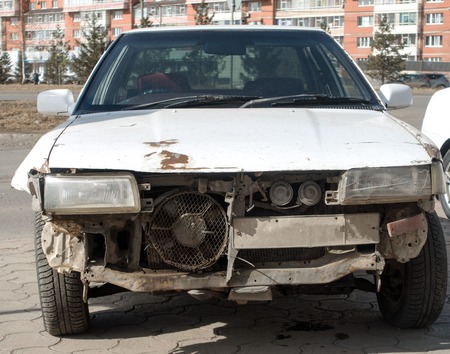 A wrecked car lays in wait after a vicious car accident.の写真素材
