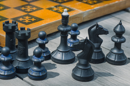 chess pieces on a wooden table closeupの写真素材