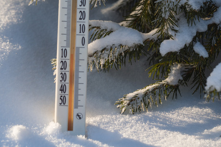 the thermometer in the forest on a cold winter dayの写真素材