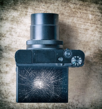 camera with a broken screen on the table top viewの写真素材
