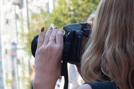 girl with a camera on a city streetの写真素材