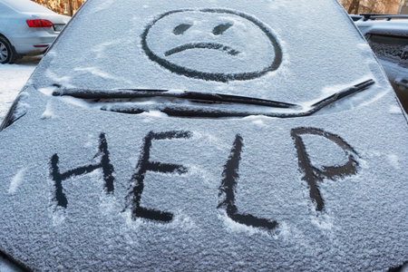 Closeup of wipers and frosted car windshield covered with ice and snow. Winter weather, transportation concept.の写真素材