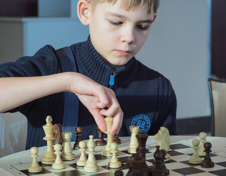 Krasnoyarsk, Russia-January 28, 2018 : city blitz tournament in chess club. The young man makes a move at the chessboard.のeditorial素材