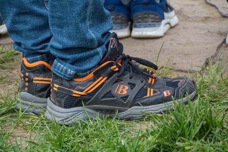 Krasnoyarsk, Russia-June 02 2019 : man in blue jeans and sneakers New balance in the Park.のeditorial素材