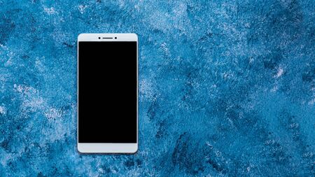 smartphone on abstract blue background.の写真素材