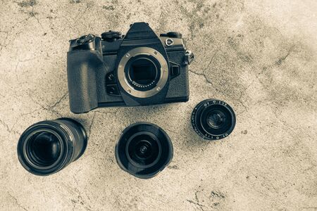 digital camera and three lenses on the table, close-up, top view.の写真素材