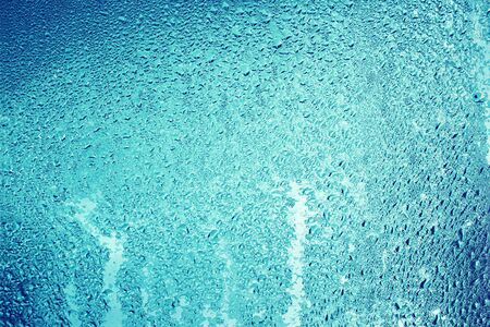 Rain drops water on glass window background.の写真素材