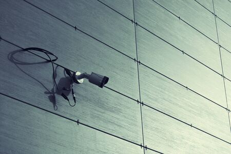 Video surveillance camera on a wall of the building.の写真素材