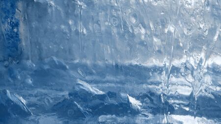 Block of ice close-up. Ice structure close-up, frozen water with cracks.の写真素材