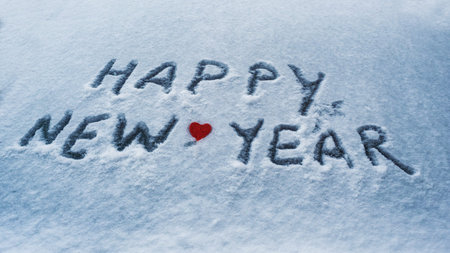 the inscription happy new year and a heart in the snow, christmas decoration.