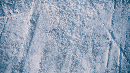 Abstract background of scratches on the light blue ice surface.