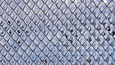 Fence covered with hoarfrost on a frosty winter day.の写真素材