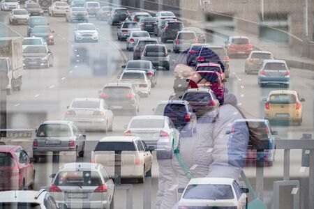 a girl in an antiviral mask on the background of an urban landscape, double exposure.の写真素材