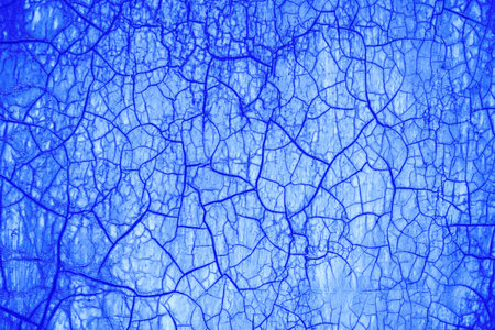 Cracked surface, abstract blue background.