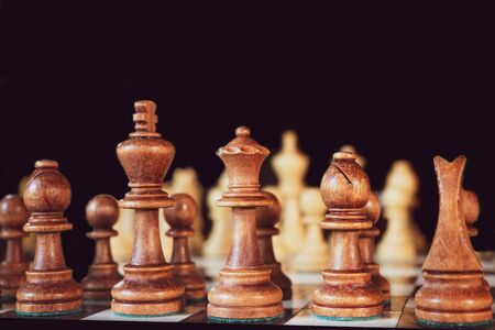 chess pieces on a table on a black background.の写真素材