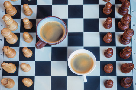 Two cups of coffee on a chessboard. Competition in business and life.