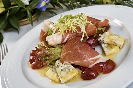 meat salad with ham cheese lettuce Dorblu grapes and olive oilの写真素材