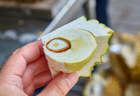 man cleans the market of exotic fruit durian in Thailand