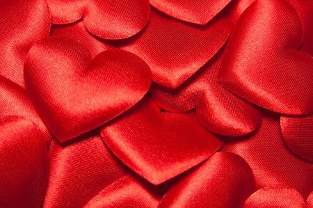 Many big colorful red silk hearts.  Vlentines day background with red hearts.の写真素材
