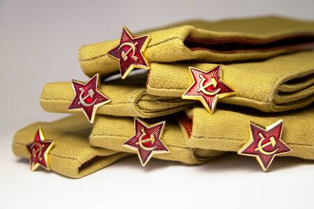 Stack of military caps of the Soviet army with red stars. Garrison cap with a red stars. Red stars with sickle and hammer. Concept for the May 9 Victory Day.の写真素材