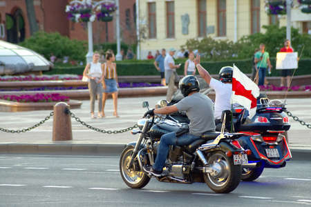 Minsk, Belarus - August 17, 2020:  Street protest against government. Bikers support the protest and carry a white-red-white flag.のeditorial素材