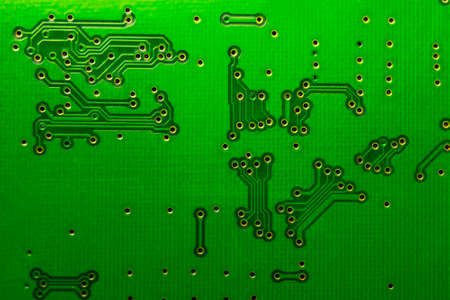 Fragment of a green printed circuit computer board with tracks. PCB  without radio components, only vias.の写真素材
