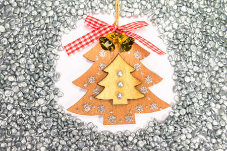 Handmade decoration Christmas plywood tree among zinc granules. Symbol of the New year. Top view. Industrial background concept for calendar.の写真素材
