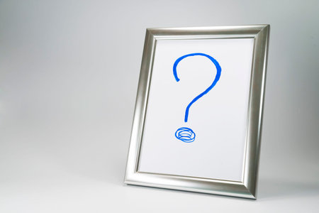 Hand drawn big blue question mark  in silver frame for the photo. Problem and solution concept in...