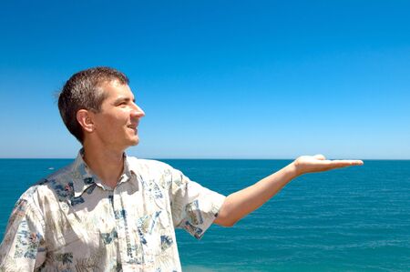 man holding the skies at the seaの写真素材