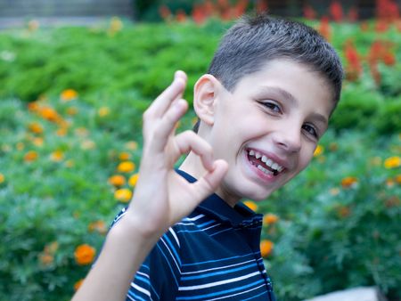 a successful teen is sitting  in the flowersの写真素材