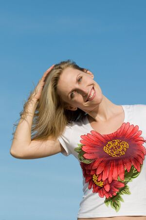 a woman is playing with her hair outdorsの写真素材
