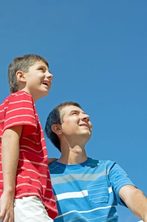 a father and his son are enjoying life outdoorsの写真素材