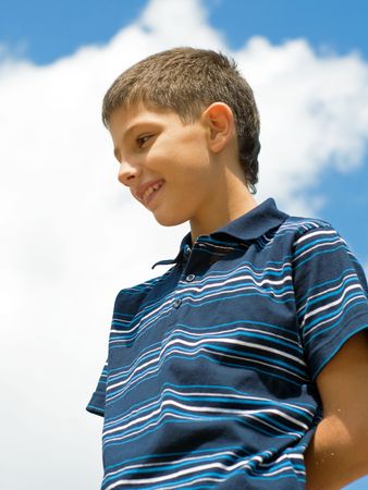 a smiling teen is looking downの写真素材