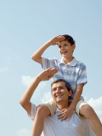 a father and his son are looking forwardの写真素材