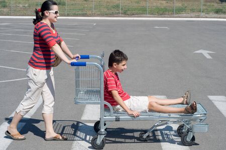 a mom and son are going for a weekend shoppingの写真素材