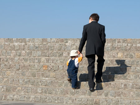 an older brother is walking with his youngeの写真素材