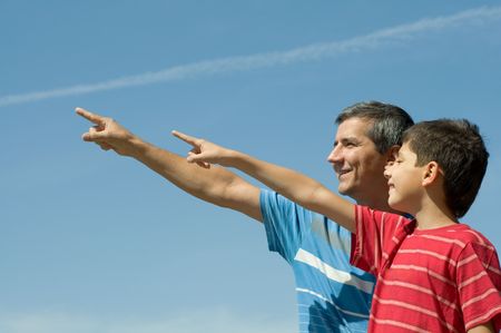 a father and his son are loking forwardの写真素材
