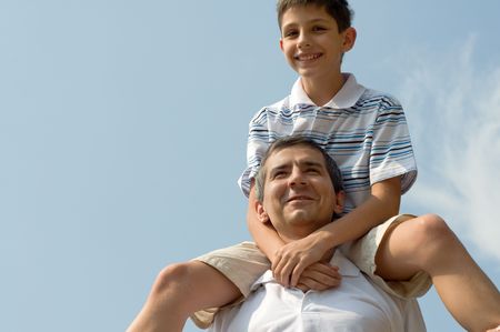 a father and his son are enjoing a sunny dayの写真素材