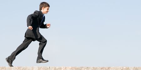 a successful and happy school student is running home の写真素材