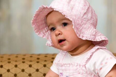a portrait of a baby in pink suit and hatの写真素材