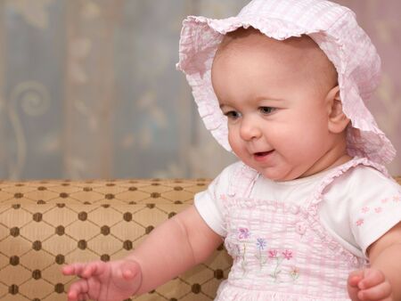 a portrait of a baby in pink suit and hatの写真素材
