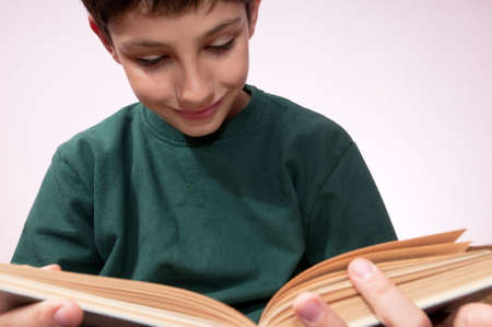 A portrait of a reading boy with a bookの写真素材