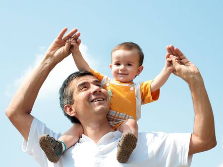 Father and his little son are playing outdoorの写真素材